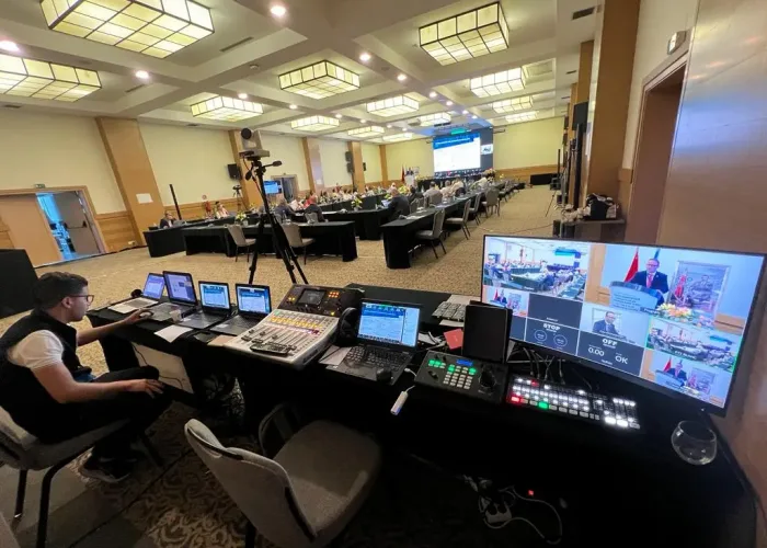 Matériel audiovisuel professionnel comprenant des microphones, caméras et systèmes de sonorisation dans une salle de conférence moderne